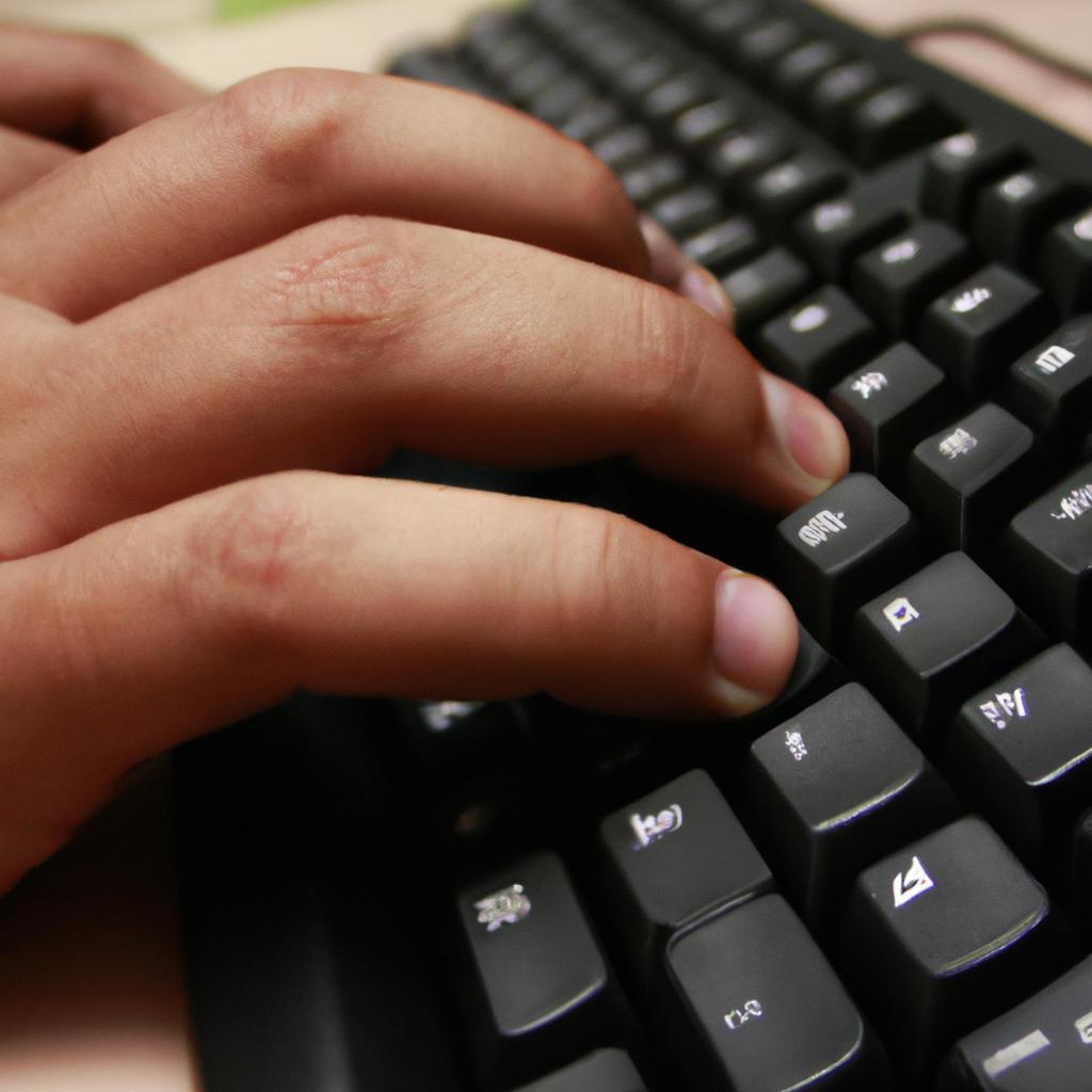 Person typing on computer keyboard